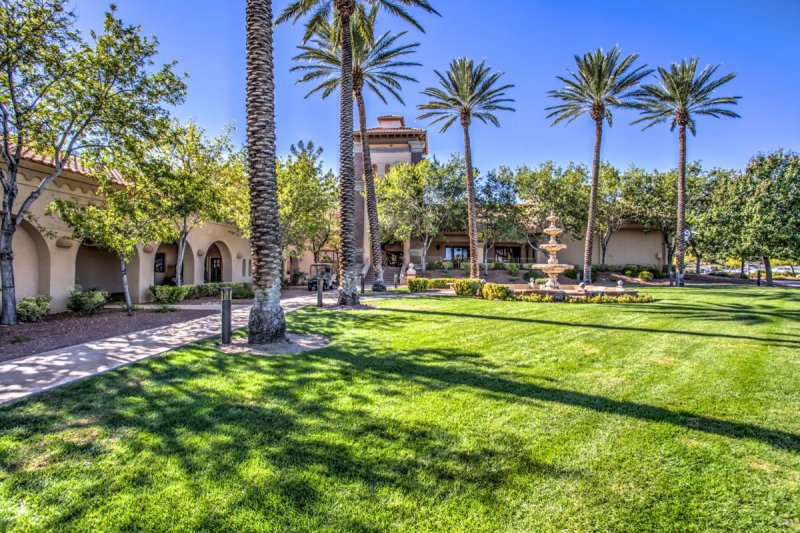 Palm trees surrounding a green lawn on the grounds of Sun City Summerlin in Las Vegas, Nevada.