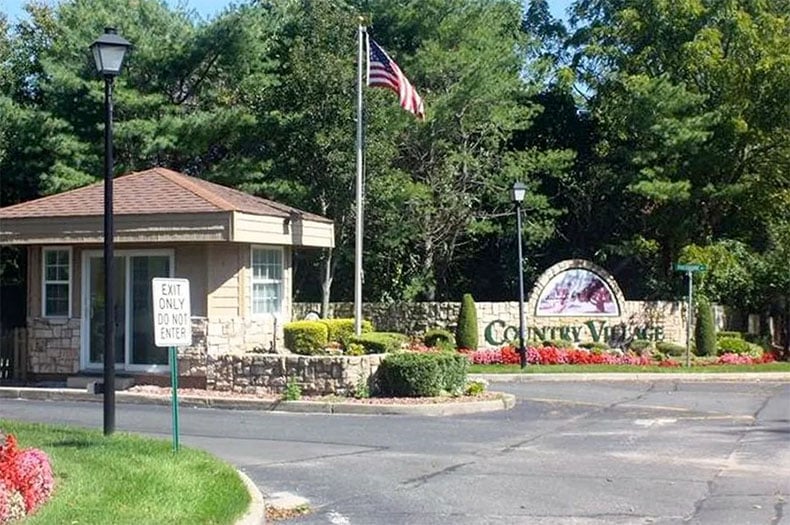 Entrance sign and gate to Country Village Estates, NY