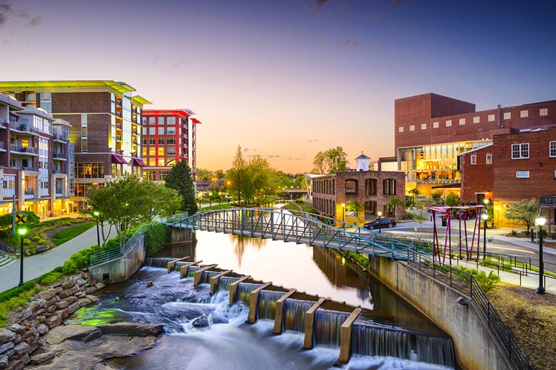 Late evening view of Greenville buildings along the Reedy River in Greenville, South Carolina.