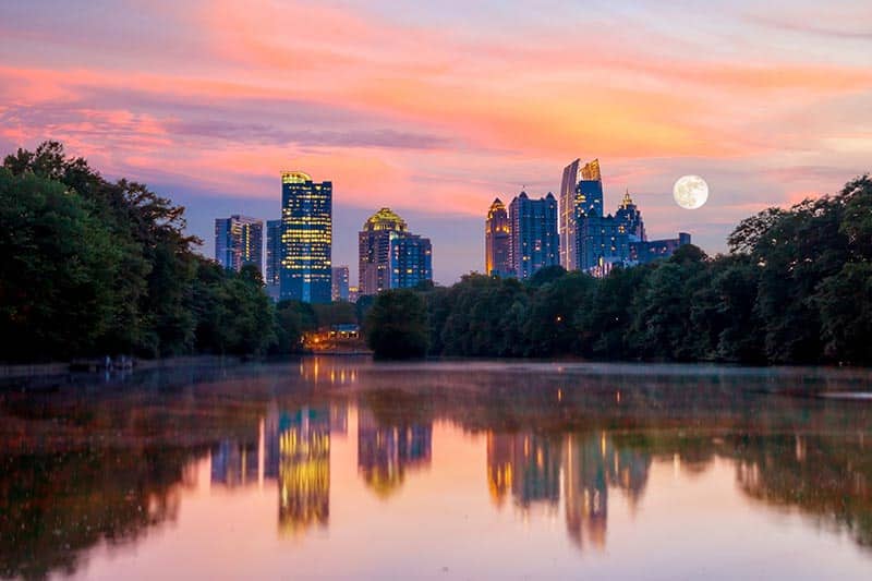 View of the Atlanta skyline at dusk from Piedmont Park's Lake Meer.