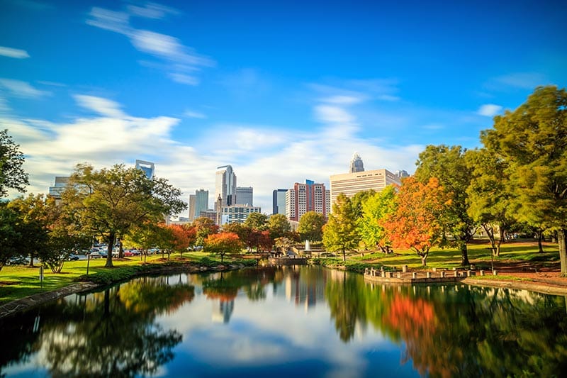 View across a pond of the skyline of Downtown Charlotte in North Carolina.