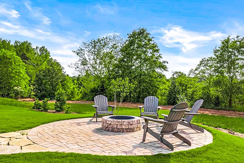 Chairs around an outdoor fire pit on the grounds of Elmwood Cottages in Boiling Springs, South Carolina