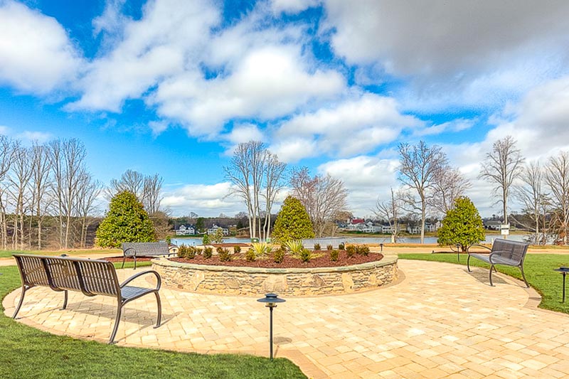 Benches along an outdoor walkway on the grounds of Lake Walk Freedom Homes, a 55+ community in Mooresville, North Carolina.