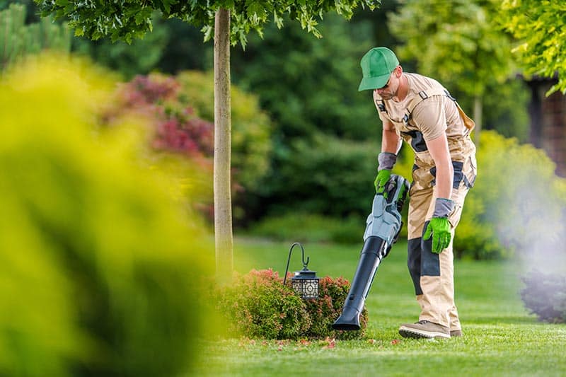 A landscaper working on the grounds of a 55+ community.