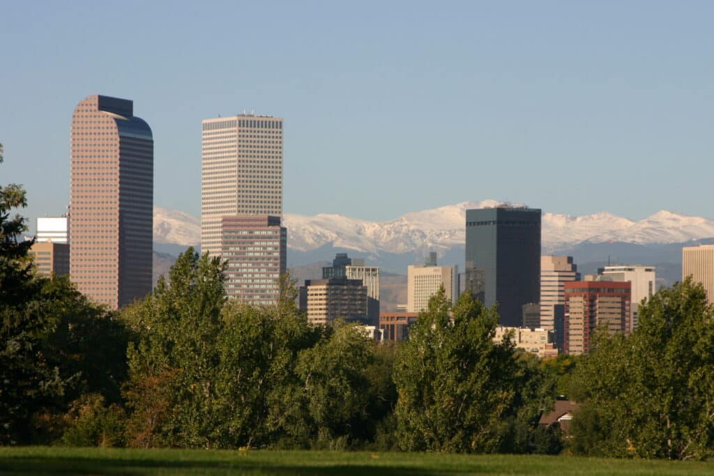Denver, CO skyline with snow capped mountains in the background