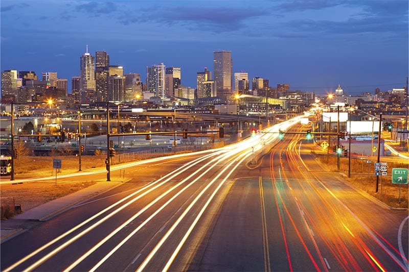 Time lapse view of cars on freeway going through Denver at night.