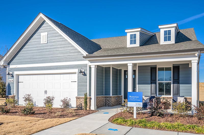 Exterior view of a model home at Del Webb Carolina Gardens, Fuquay-Varina, North Carolina on a sunny day.