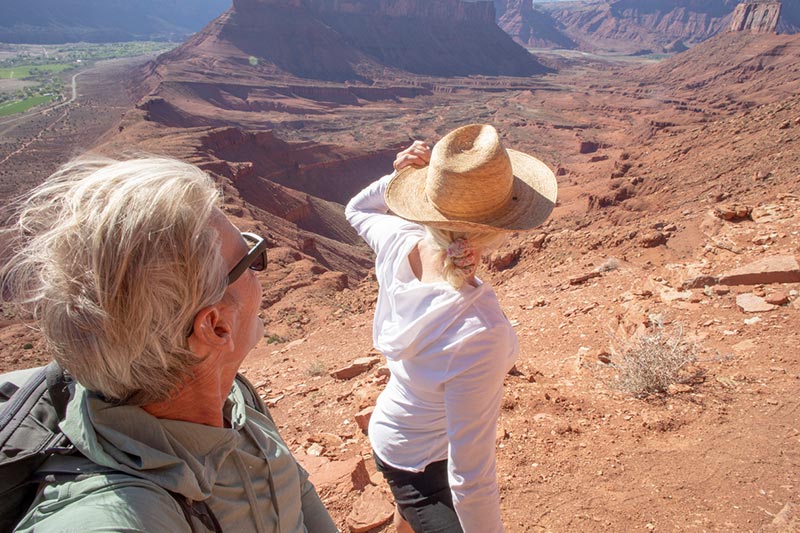 A senior couple takes a hike in a low-humidity state they chose for their retirement.