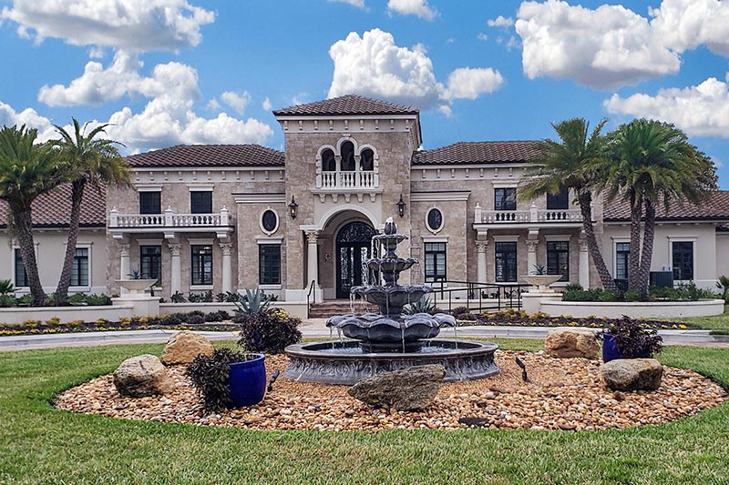 A fountain and palm trees at the entrance of Artisan Lakes in Ponte Vedra, Florida.