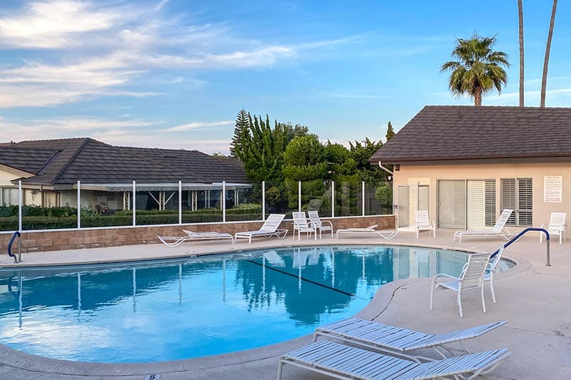 Lounge chairs beside the outdoor pool at New Horizons South Bay in Torrance, California.