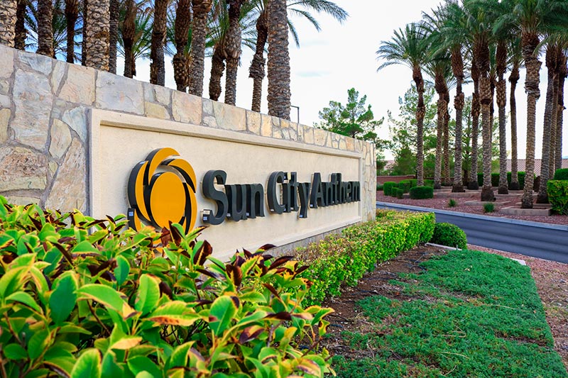 Palm trees surrounding the community sign at Sun City Anthem in Henderson, Nevada.