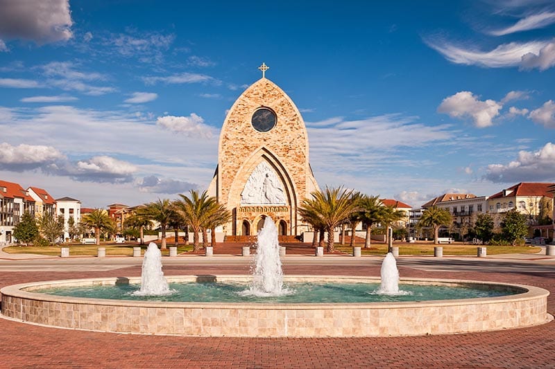 Fountain at Ave Maria university with old church in the background.