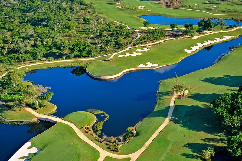 Small lake surrounded by golf course.