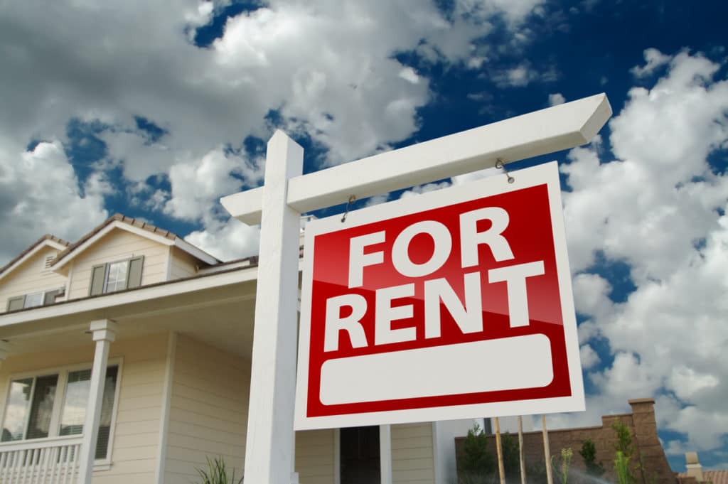 A for rent sign is in the front yard of a home for rent in a 55+ community.