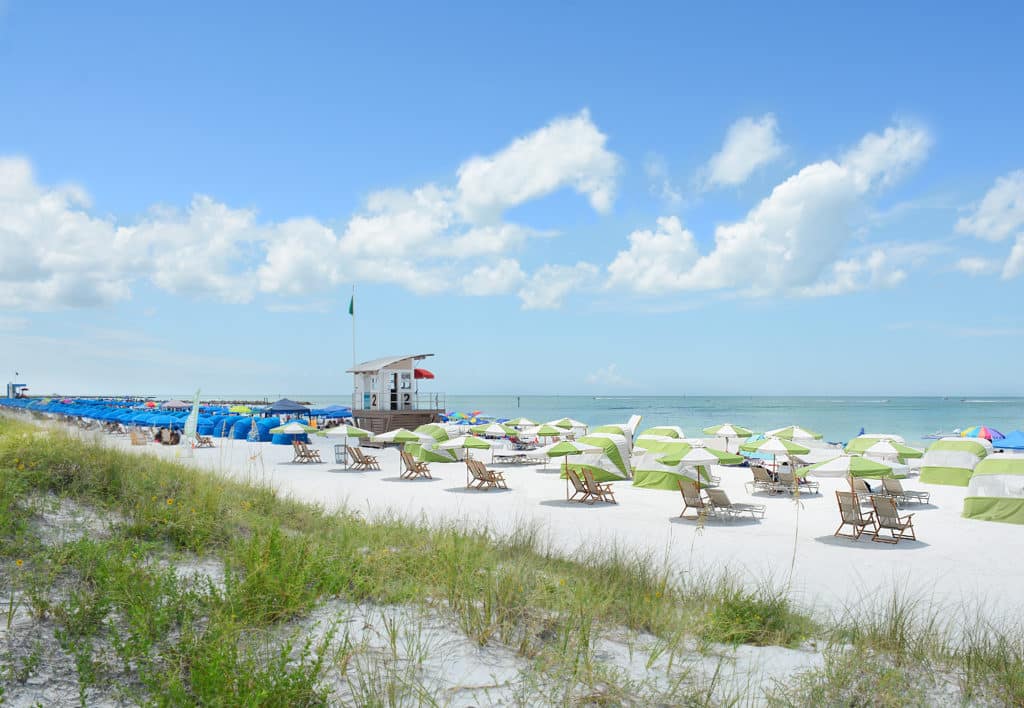 Beach chairs and parasols on a white sand beach at Clearwater Beach in Florida.