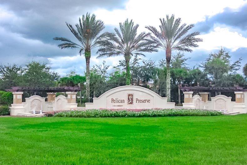 Palm trees behind the entrance sign at Pelican Preserve in Fort Myers, Florida.