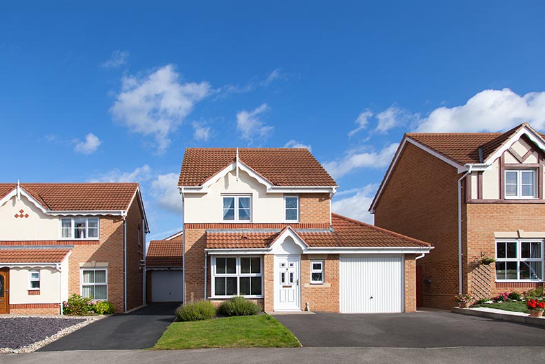 Front view of a row of detached houses on a sunny day.