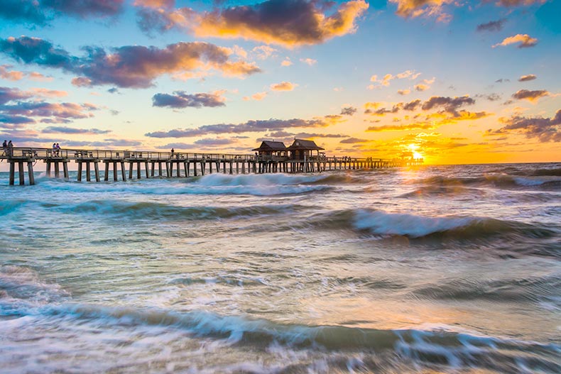 Sunset over the fishing pier and Gulf of Mexico in Naples, Florida.