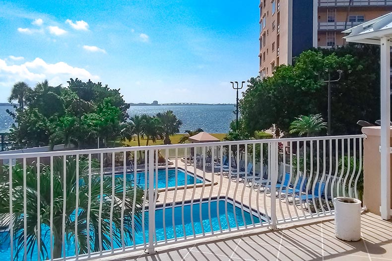 View from a balcony of lounge chairs beside the outdoor pool at Town Shores of Gulfport in Gulfport, Florida.