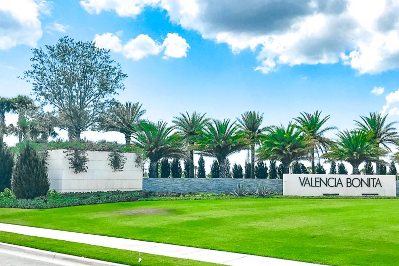 Palm trees surrounding the community sign at Valencia Bonita in Bonita Springs, Florida.