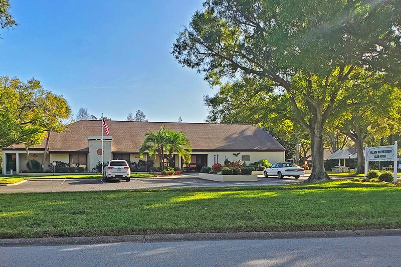 A tree beside the community building at the entrance to Village on the Green in Clearwater, Florida.