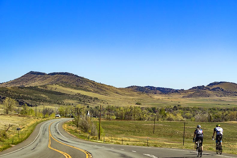 Bikers on a road along the Rocky Mountains foothills near Boulder, Colorado.