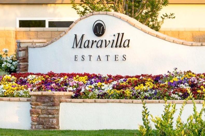 Flowers surrounding the community sign for Maravilla Estates in San Jacinto, California.