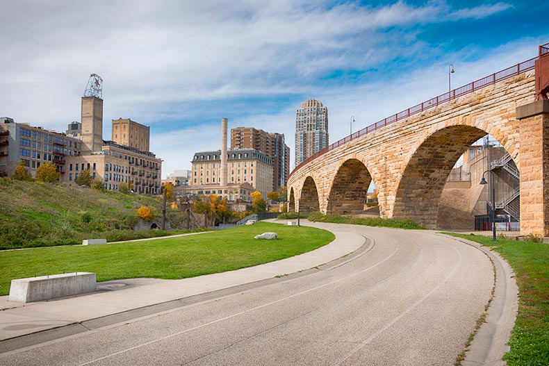 The Stone Arch Bridge and bike path with a view of the Minneapolis skyline in Minnesota.