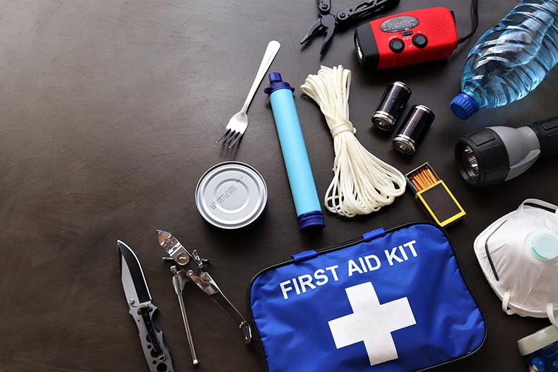 Items on a table that are part of a survival kit for natural disasters.