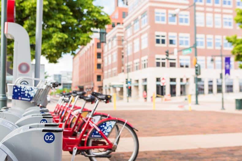 A row of red rental bikes parked at the rental staiton near Denver Union Station.