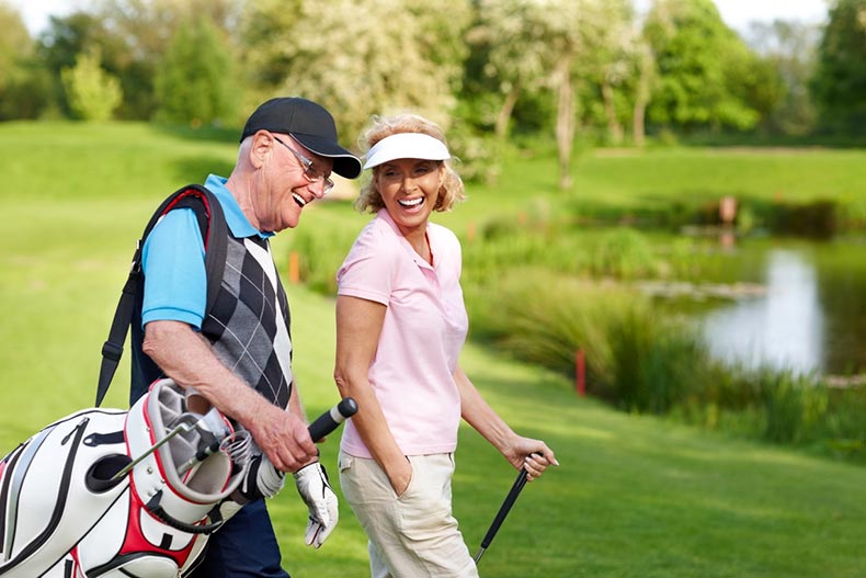 Two seniors playing golf have improved their scores with a free golf handicap app.