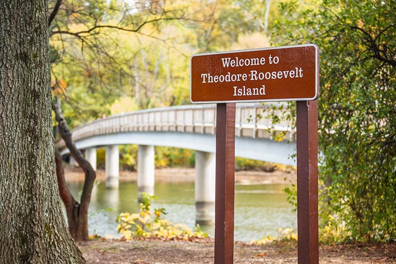 The welcome sign at Theodore Roosevelt Island in Washington, DC on a sunny day.