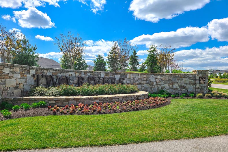 Greenery surrounding the community sign for Two Rivers in Odenton, Maryland.