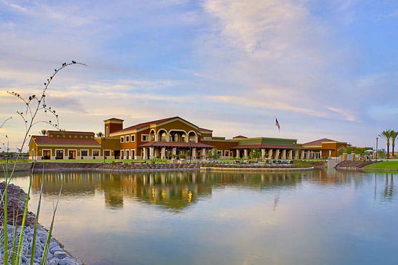 View across the water of the clubhouse at CantaMia at Estrella in Goodyear, Arizona.