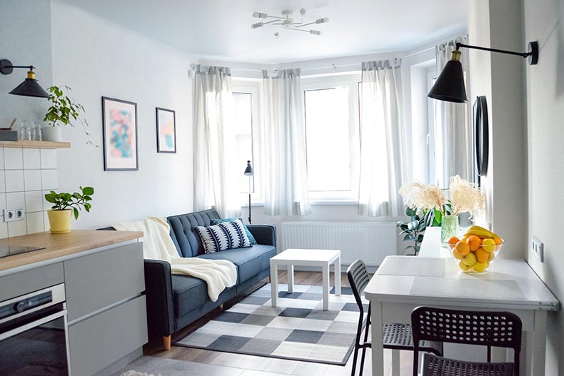 A kitchen and living space in a cozy, clean home.