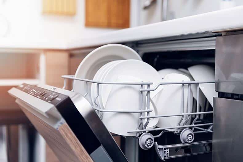 Clean dishes in a dishwasher.