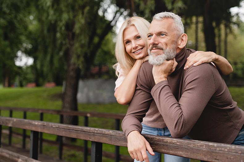 Happy couple embracing in a city park.