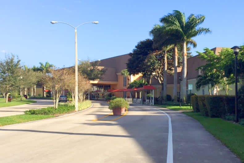 Palm trees beside the entrance to Kings Point in Delray Beach in Delray Beach, Florida.