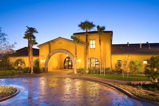 a home at night, driveway view