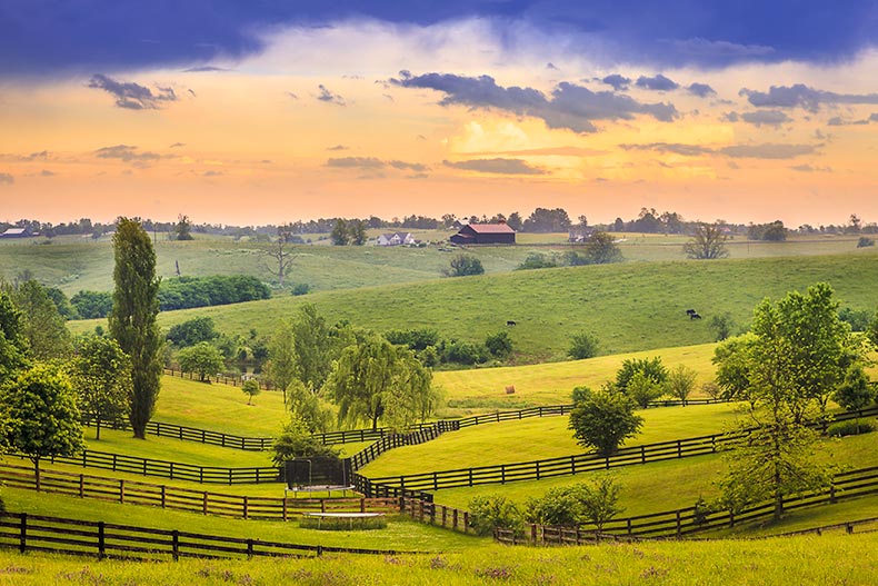 A sunset over pastures and green fields in Kentucky.