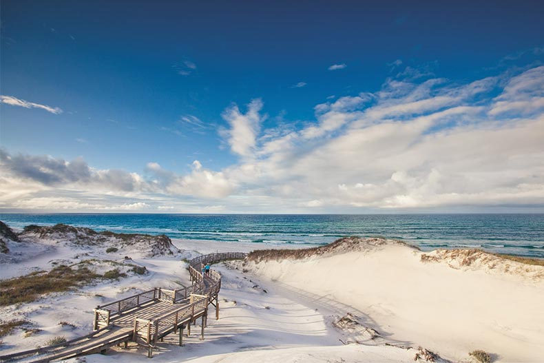 A boardwalk beside a beach near Latitude Margaritaville Watersound in Panama City Beach, Florida.