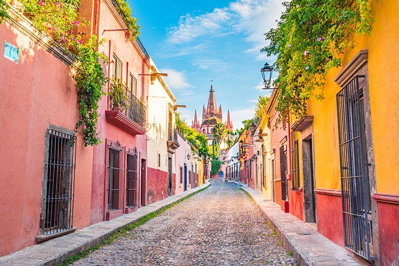 View down a street with the colorful facades of San Miguel de Allende in Guanajuato, Mexico.