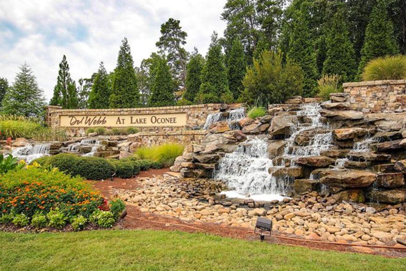 A waterfall beside the community sign for Del Webb at Lake Oconee in Greensboro, Georgia.