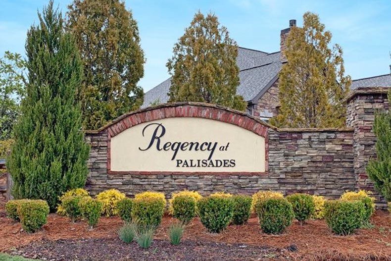 The community sign surrounded by trees at Regency at Palisades in Charlotte, North Carolina.