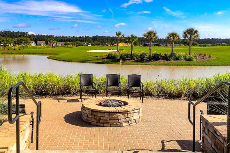 Chairs around a fire pit beside a pond on the grounds of Sun City Hilton Head in Bluffton, South Carolina.