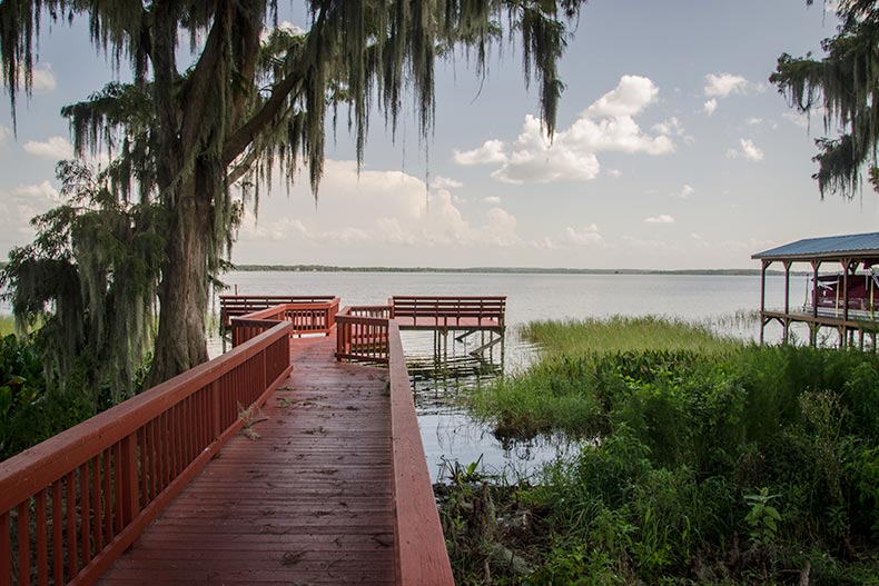 A dock extending onto a lake on the grounds of Royal Harbor in Tavares, Florida.