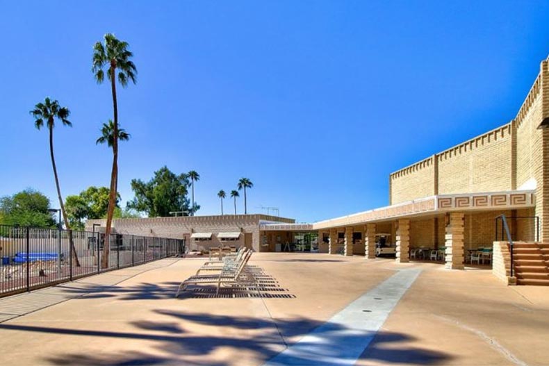 Lounge chairs and palm trees on the grounds of Sun City in Sun City, Arizona.