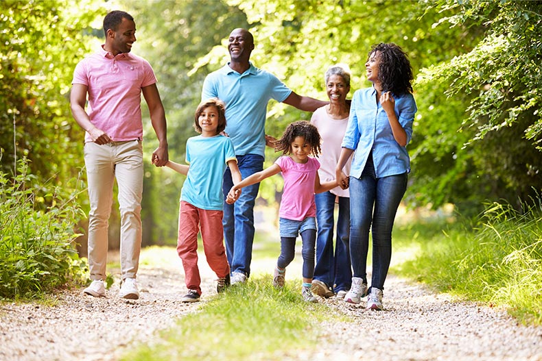 A multigenerational family enjoying a walk on a sunny day.