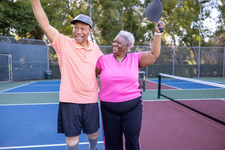 A senior couple play pickleball in their 55+ community.