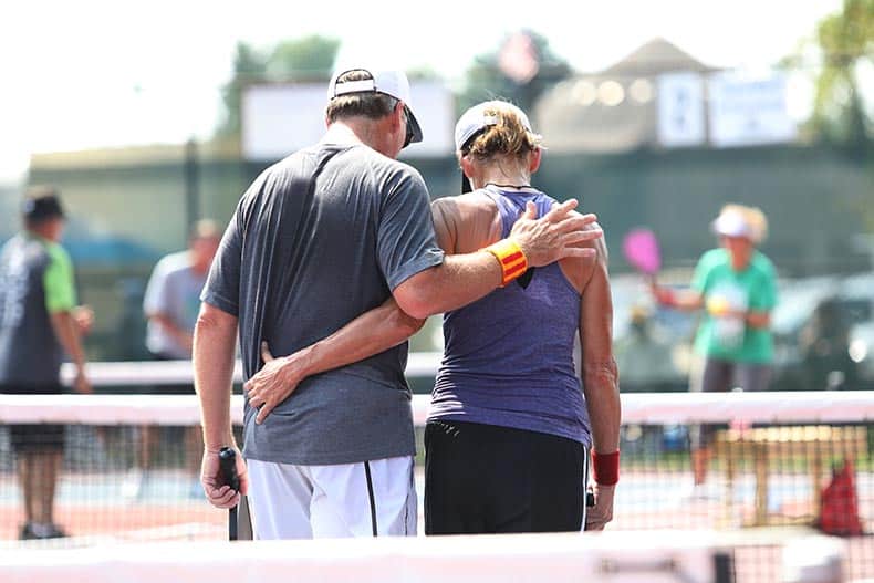 A mixed doubles team console each other after a match.